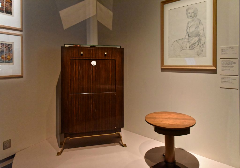 Jules-Émile Leleu (1883-1981)  Au fond, secrétaire avec piètement en bronze doré et devant, petit guéridon tripode acajou et métal 1938. . Leleu a réalisé plusieurs guéridons et petit mobilier pour les suites du Normandie.
